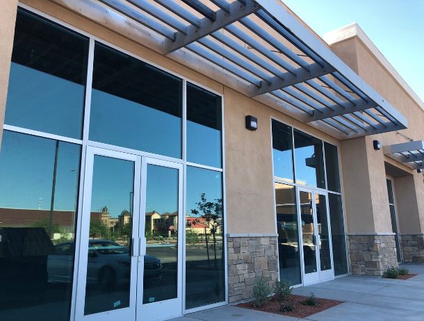 Refreshed glass and stucco building facade completed by Houston commercial general contractor